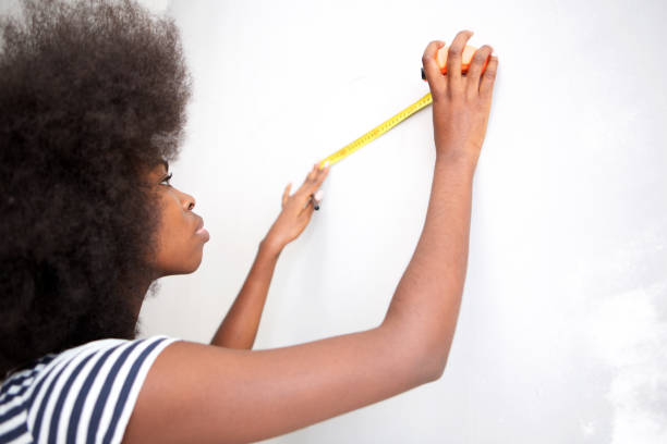istock attractive young black woman doing home improvement 1076016862