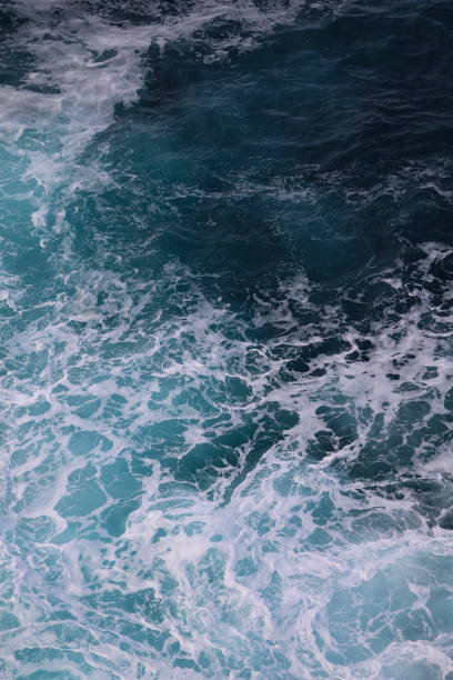 istock blue and white foamy ocean waves 1076017682