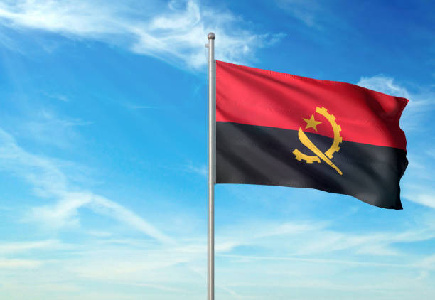 istock Angola flag waving cloudy sky background realistic 1076020008
