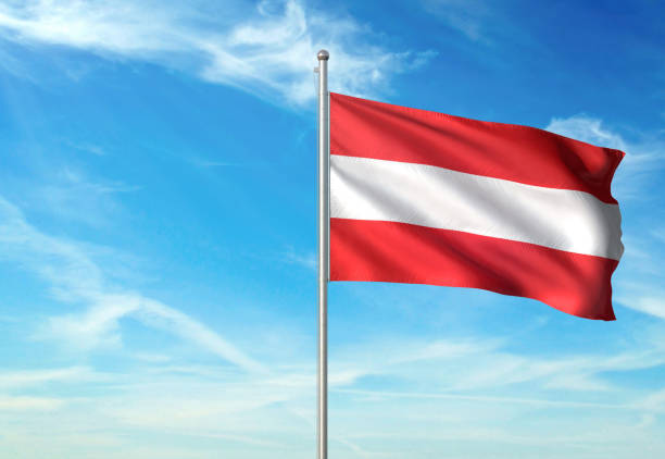 istock Austria flag waving cloudy sky background realistic 1076020668