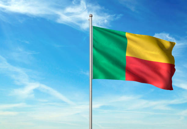 istock Benin flag waving cloudy sky background realistic 1076021206