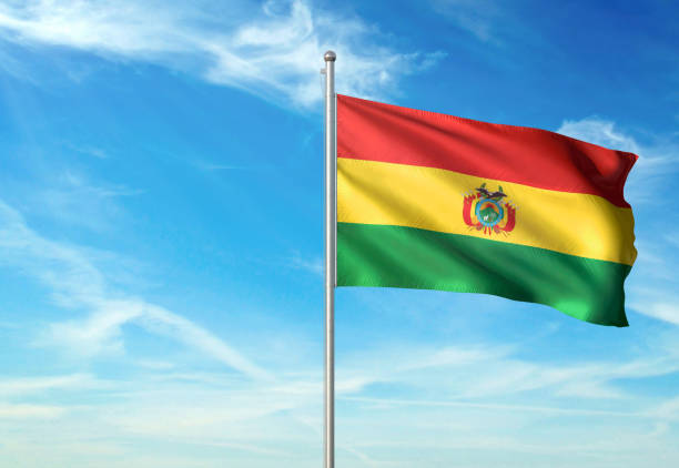 istock Bolivia Plurinational State flag waving cloudy sky background realistic 1076021234