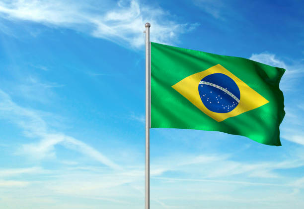 istock Brazil flag waving cloudy sky background realistic 1076021248