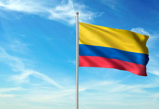 istock Colombia flag waving cloudy sky background realistic 1076022360