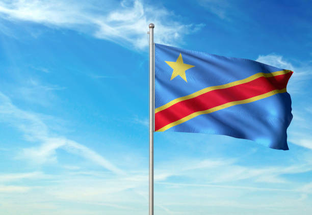 istock Congo The Democratic Republic flag waving cloudy sky background realistic 1076022364