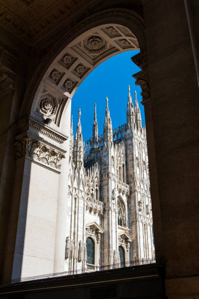 istock Duomo cathedral view through arched window in Milan, Italy 1076025318