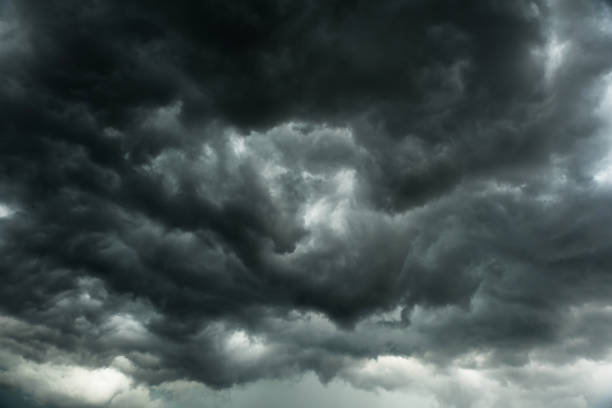 istock Dramatic black clouds before rainy, Motion heavy storm and dark sky in summe, Bad weather with black cumulonimbus clouds movement 1076027942