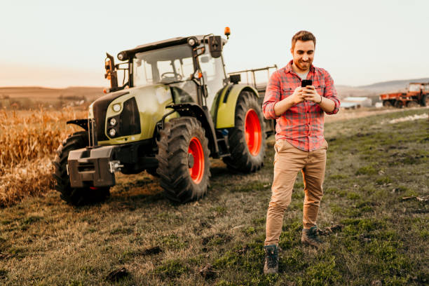 istock Farmer working on field using smartphone in modern agriculture 1076028776