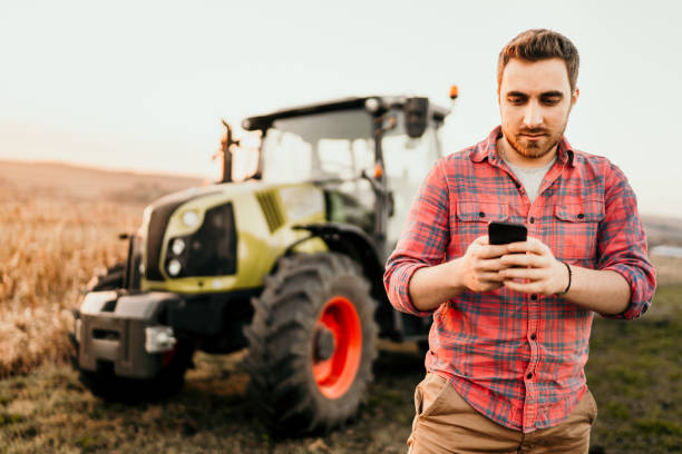 istock Farmer using smartphone for controlling organic harvest 1076028836