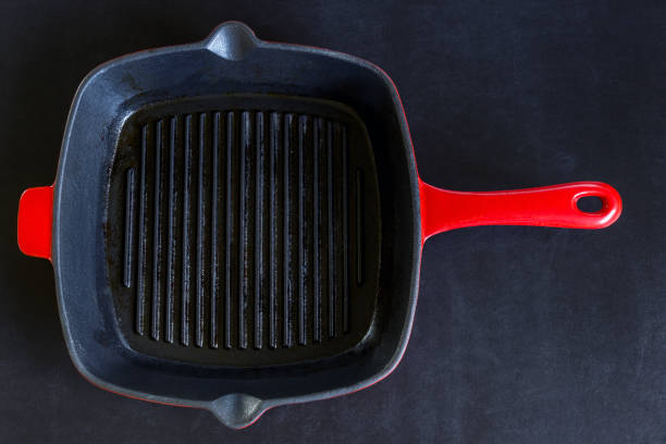 istock Empty red grill pan on black background. Copy space. Concept- cooking, menu, recipes. 1076030888