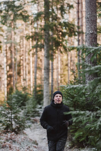istock Man outdoors in winter doing exercise and training in cold frost weather 1076033218