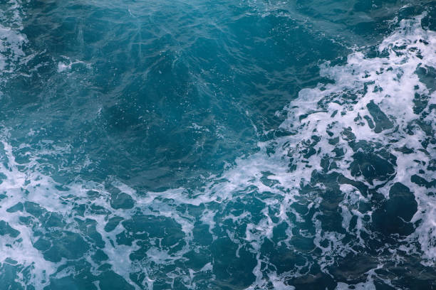istock blue and white foamy ocean waves 1076033916
