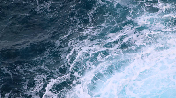 istock blue and white foamy ocean waves 1076036546