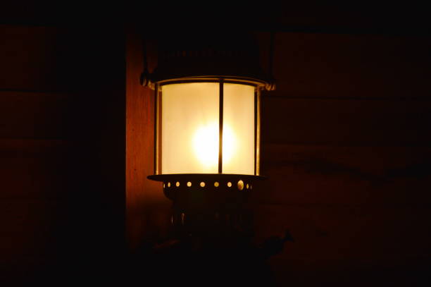 istock electric lamp hanging on wall in the night 1076040186