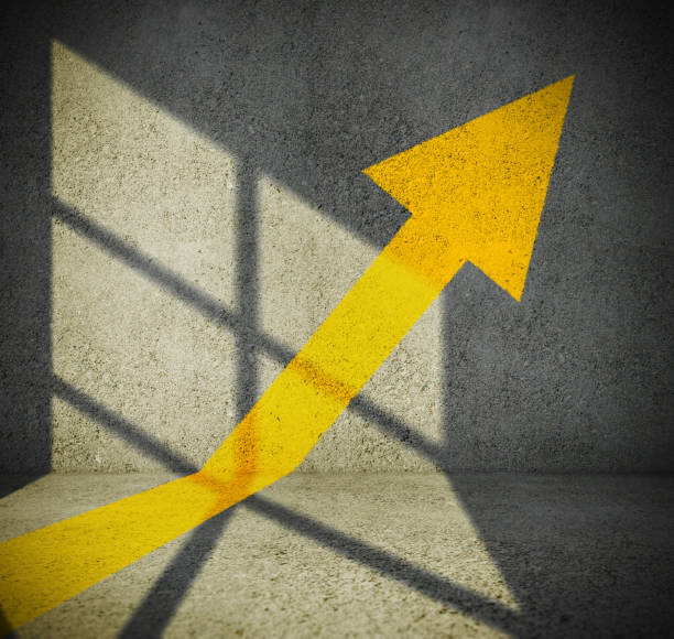 istock Single yellow arrow on wall pointing up 1076040844
