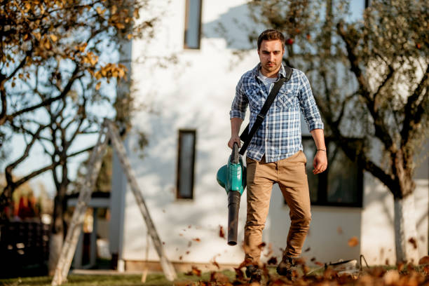 istock Portrait of worker using leaf blower in garden, autumn details 1076044148