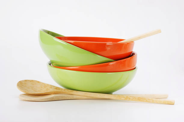 istock stack of clean empty plates and wooden spoons  on white background 1076045012