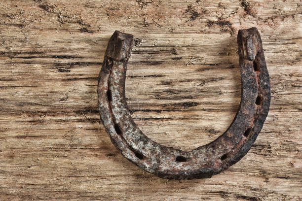 istock old rusty horseshoe on a wood background 1076045104