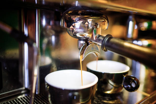 istock Two espresso pouring from espresso coffee machine. Hot beverages, coffee preparation and barista details 1076045324