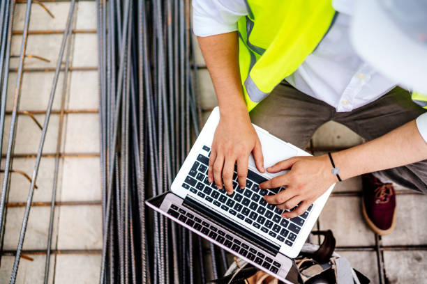 close up details of engineer working on laptop on construction site - computer construction using laptop construction site imagens e fotografias de stock