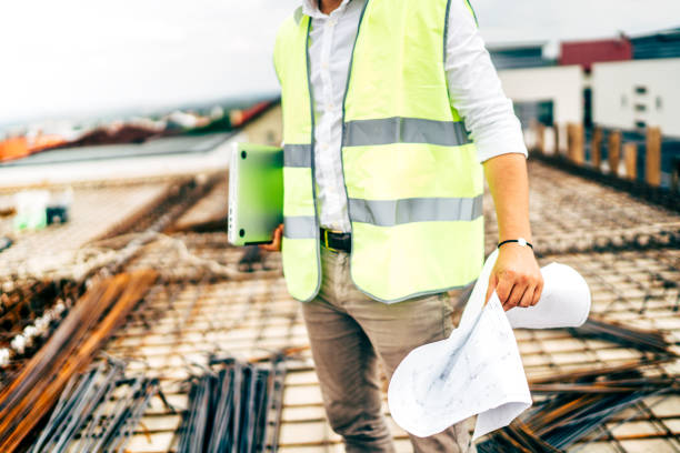 istock details of construction worker, engineer wearing safety vest and laptop on construction site 1076046366