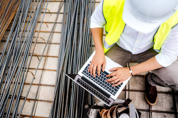 istock close up details of worker on construction site using laptop 1076046380