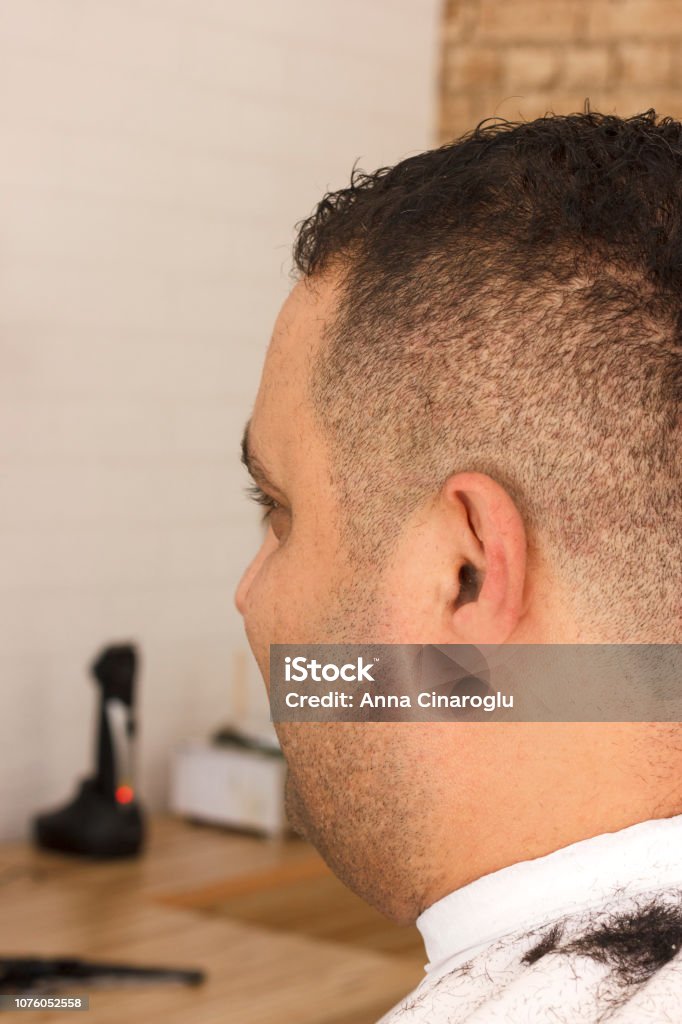 Back View Of Man Getting Short Hair Trimming At Barber Shop With Clipper  Machine Stock Photo - Download Image Now - iStock