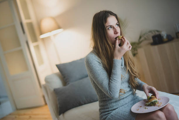 istock woman eating and drinking 1076053864