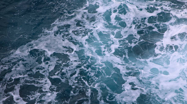 istock blue and white foamy ocean waves 1076054376