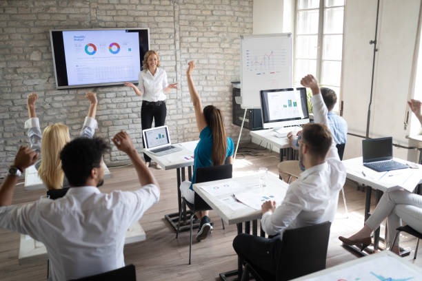 istock Successful happy group of people learning software engineering and business during presentation 1076058020