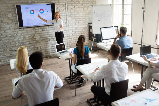 istock Successful happy group of people learning software engineering and business during presentation 1076058022