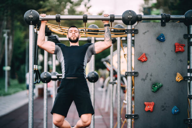 istock Athlete working out in park, arms and back exercises - pull-ups 1076058118