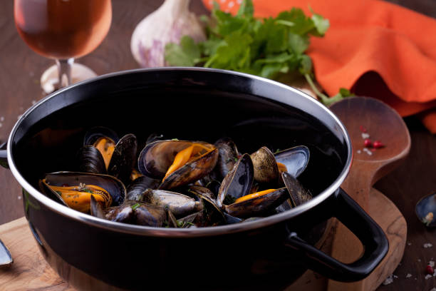 istock Freshly cooked mussles in herbs and white wine 1076058338