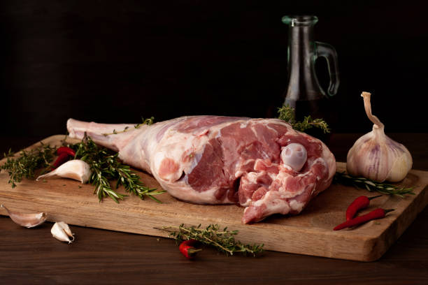 istock Fresh raw lamb leg ready for roasting with garlic and herbs 1076058450