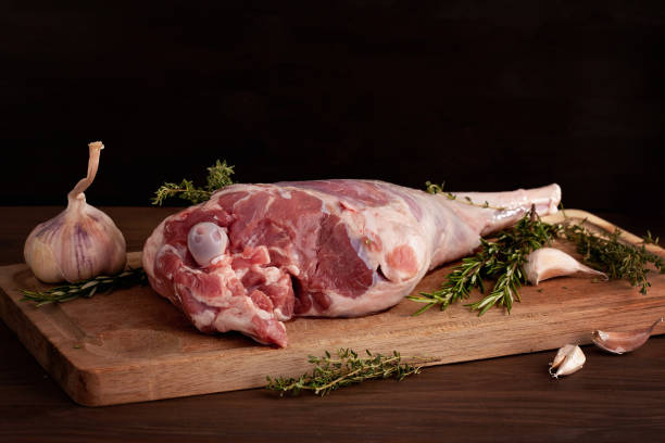 istock Fresh raw lamb leg ready for roasting with garlic and herbs 1076058456