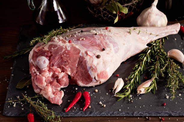 istock Fresh raw lamb leg ready for roasting with garlic and herbs 1076058492