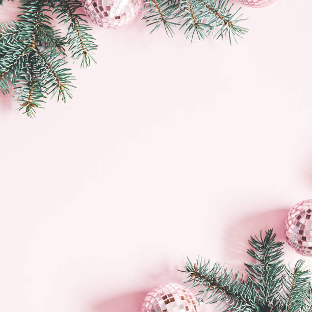 istock Christmas composition. Frame made of fir tree branches, pink balls on pastel pink background. Christmas, winter, new year concept. Flat lay, top view, copy space, square 1076058732