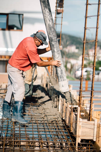 istock details of construction site. Builder operating cement pump 1076059086