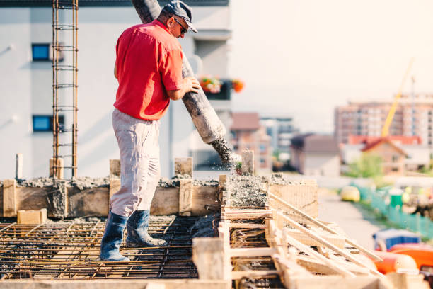 istock construction worker pouring concrete in construction site, building details, industry 1076059194