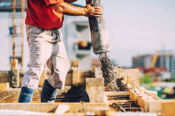 istock building construction worker pouring cement or concrete with pump tube 1076059282