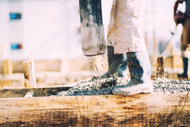 istock Constuction details - worker laying cement or concrete with automatic pump