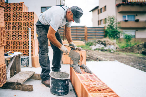 istock Construction industry details - Worker mason building exterior brick walls 1076060244