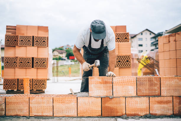istock Close up details of industrial bricklayer installing bricks on construction site