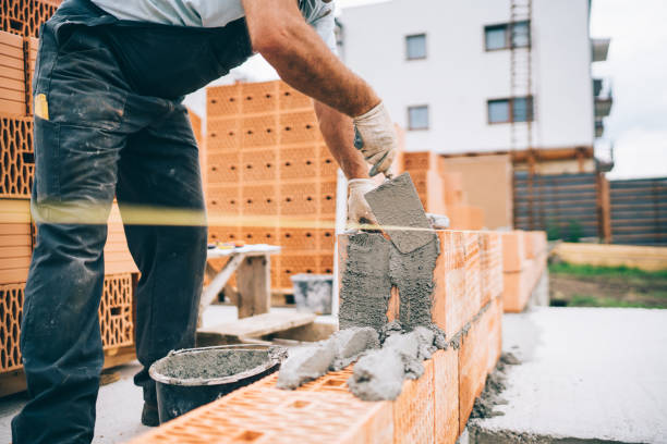 istock Close up of details of industrial bricklayer installing bricks on building construction site 1076060578