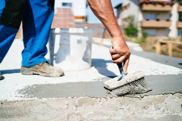 istock industrial worker on construction site laying sealant, flooring details 1076062444