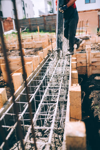 istock worker pouring concrete with concrete pump 1076063732