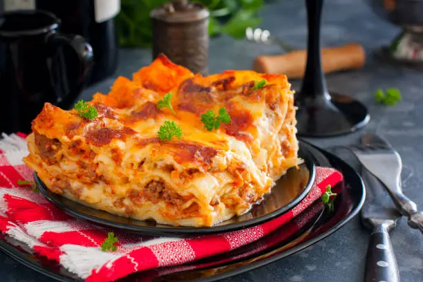 Photo of Traditional Italian Lasagna Bolognese with minced meat and tomato sauce, horizontal