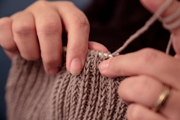 istock Close up on woman's hands knitting 1076072158