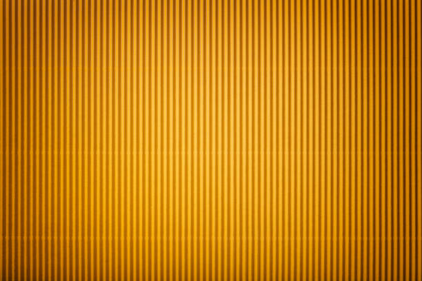 istock Texture of corrugated yellow paper with vignette, macro. 1076076764