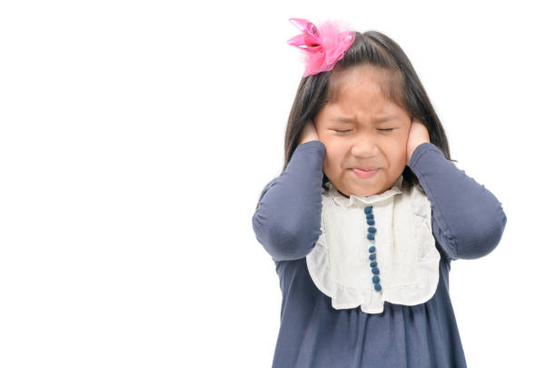 istock child covering ears with hands from the noise. 1076080822